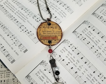 Heartsongs - Never Grow Old is an altered wood poker chip with paper hymn snippets, metal findings and charms