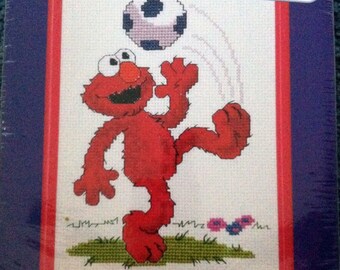 Elmo Soccer Cross Stitch Kit Janlynn Sesame Street Elmo from Sesame Street is kicking a soccer ball.