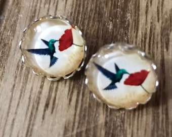 Silver stud blue bird earrings with a glass insert.