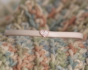 Off-white leather bracelet with crystal heart charm