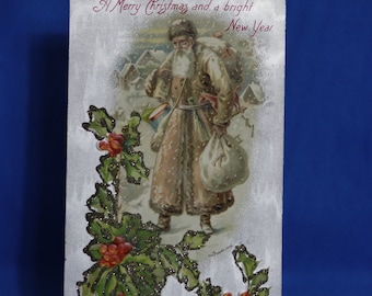 Vintage Santa Clause postcard in brown suit with glitter