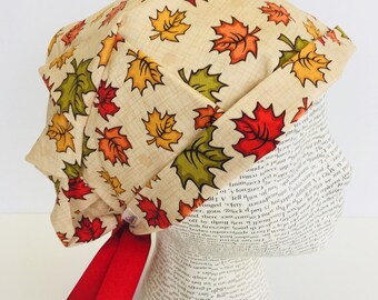 Ribbon Tie Back Scrub Cap scrub hat featuring a beige material with fall colored leaves and a matching ribbon