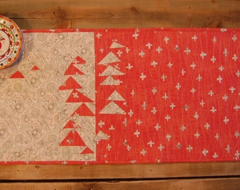 Quilted table runner in soft orange, cream and black in improv flying geese pattern 16 1/2" x 34 1/2"