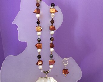 Freshwater pearls with the shell pendant