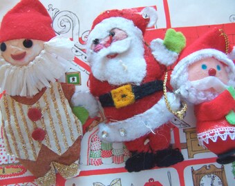 three felt and paper ornaments