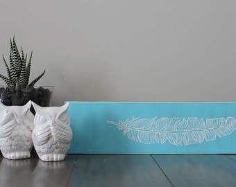 Blue hand painted feather sign