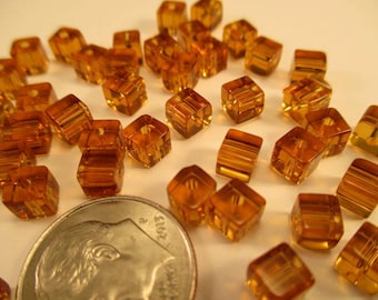 Package of 40 Amber Color Glass Cube Beads 4mm. Item:BC818771