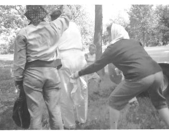 Vintage Snapshot "Ganging Up On Uncle Joe" Woman Grabbing Man's Pants Back Rear View Found Vernacular Photo