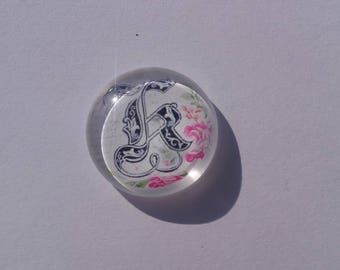 Calligraphy of the letter k on 25 mm glass cabochons