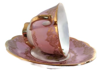 Vintage Royal Albert "violet" pattern footed tea cup with a pink/lavender background with heavy gold accents