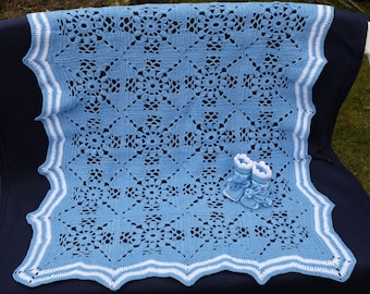 Blue cover with baby booties.