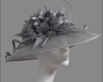 Stunning silver ladies hat with sinamay swirls, feather flower & diamanté. Weddings, races, ladies day or special occasion.