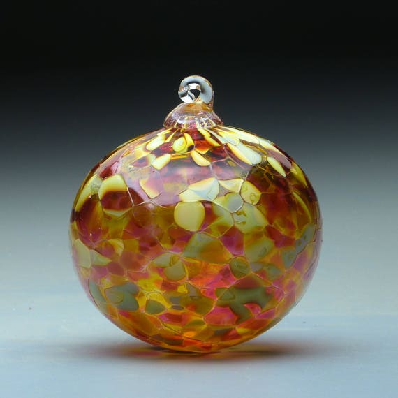 hand blown glass round Christmas ornament in tones of gold
