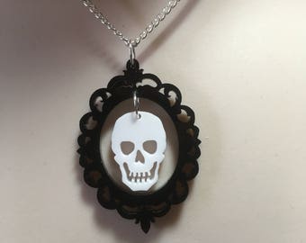 Dramatic hanging skull in a gothic frame pendant