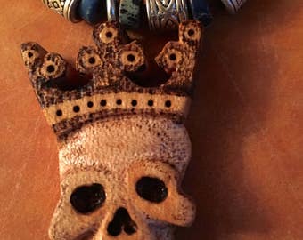 Handcarved, skull king necklace.