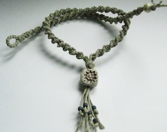 Natural colored hemp necklace with high fired ceramic bead.