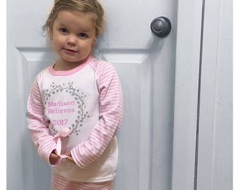 I Believe - Pink Pyjamas with silver glitter wreath and bow. Perfect for Christmas and Christmas Eve
