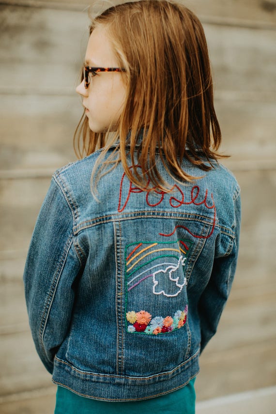 Custom hand embroidered denim jacket with name and design of