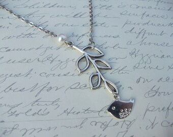 Bird on branch with pearl necklace