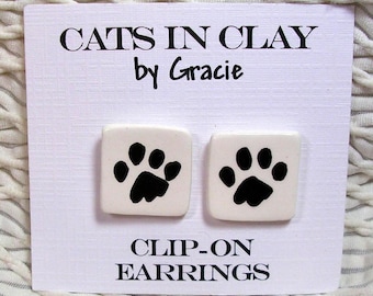 Dog Or Cat Paw Print Clip On Earrings Handmade In Kiln Fired Clay by Grace M Smith