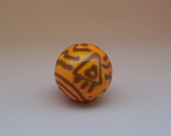 Fascinating lampwork glass marble in dark yellow with petroglyph-styled lines in brown, flamework glass art marble