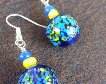 pretty navy glass bead with smaller yellow & blue bead on silver ear wire