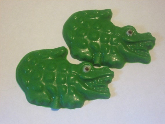 One dozen chocolate alligator candy pieces or lollipops
