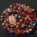 Beads and pendants from Nepal in agate, yak bone, coral, turquoise, sandalwood, glass and metal
