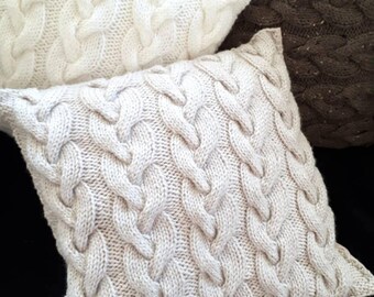 Cable handknit cushion cover.