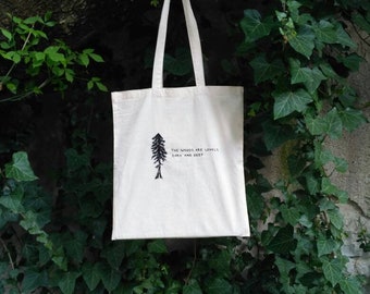Hand embroidered 'The woods are lovely, dark and deep' tote bag with a pine tree
