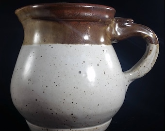 Cream and brown stoneware pitcher