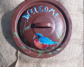 Welcome blue bird on tin lid