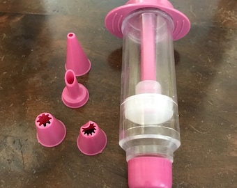 Syringe with tips for cake decoration.