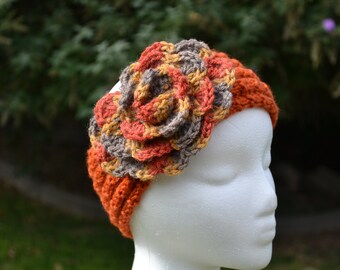 Knitted earwarmer with crochet flower