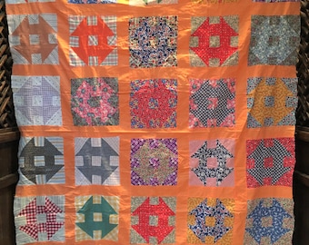 Bright batiks quilt in the Monkey Wrench pattern
