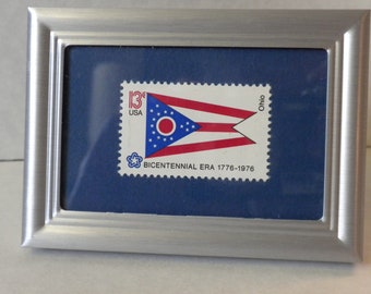 Framed picture of Ohio State Flag, framed 13 cent US mint postage stamp, in silver metal frame, collectible stamp, US Bicentennial