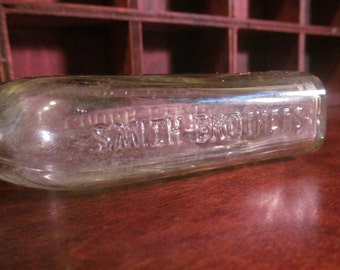 vintage apothecary bottle. cough syrup, clear glass. advertising and decorative.