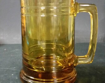 Vintage heavy amber gold beer mug with leather wrap.