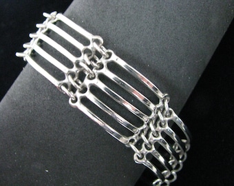 Silver tone industrial look lined link bracelet
