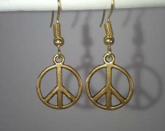 Gold peace sign dangle earrings
