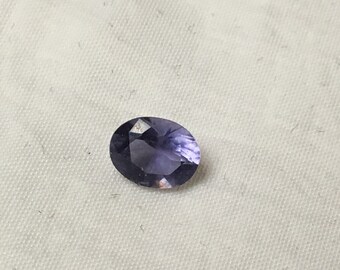 Oval faceted iolite gemstone 6x7.5mm