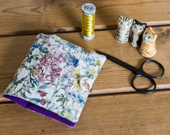 This sewing case is hand stitched in a Liberty Tana Lawn floral print called 'Wild Flowers', partnered with crisp purple cotton
