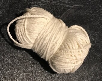 Small ball of off-white cotton about 25 m