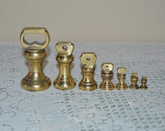 Vintage set of 7 brass bell shaped weights/ Messingglockengewichten
