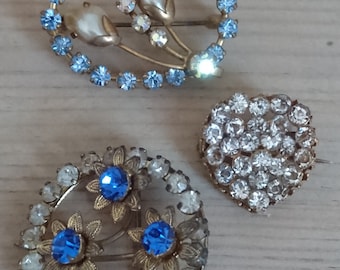 Three sparkly rhinestone brooches