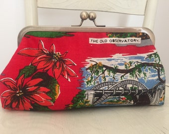 Handmade clutch from vintage Australian linen with scenes of Brisbane and a kisslock frame