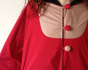 Waterproof Cape with a large red hood hot and dusty pink