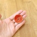 1 large red wooden button, 40mm, painted and lacquered.