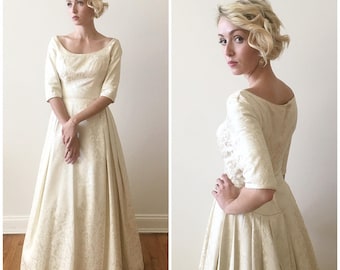 Vintage 1960s Brocade Wedding Gown with quarter length sleeves and scoop waist details.
