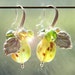 Glass lampwork green gooseberry earrings with silver color leaves.